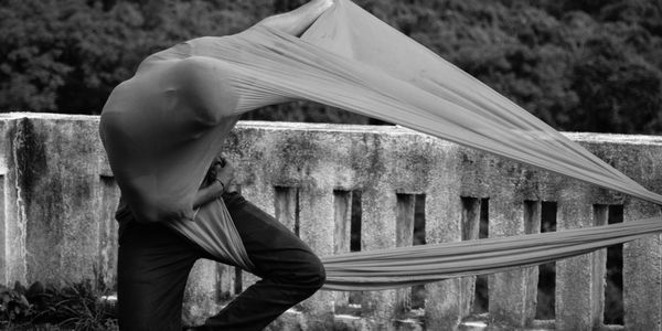 Silhouette of a person performing a gentle stretch.